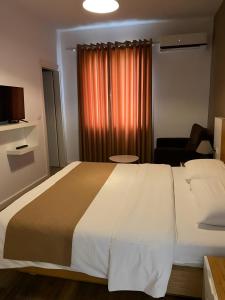 Postel nebo postele na pokoji v ubytování Hotel Sidi