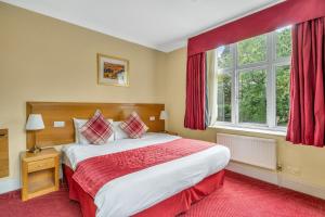 Postel nebo postele na pokoji v ubytování Dial House Hotel
