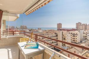 a balcony with a table and a view of a city at Apartamento Niza in Oropesa del Mar