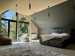 a bedroom with a bed and a large window at Apex Panorama Hotel in Yablunytsya +73 photos