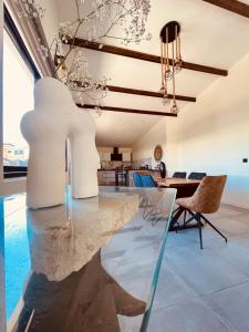 a dining room with a large marble table and chairs at Villa 'Le Grand France' in Sainte-Marie