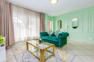 a living room with a green couch and a table at II St Tropez Sandton Luxury Suites in Johannesburg +16 photos