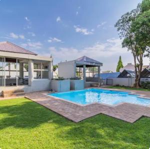 a swimming pool in the yard of a house at II St Tropez Sandton Luxury Suites in Johannesburg