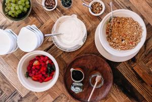 a wooden table with plates of food and bowls of fruit at Lisnacurran in Hillsborough