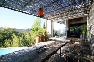 a patio with a table and a swimming pool at Villa Sainte-Claire maison avec studio in Hyères