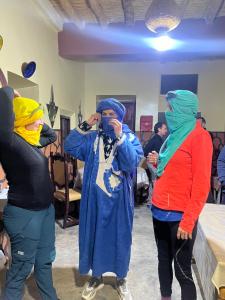 a group of people dressed in costumes standing in a room at Ounilla valley in Tizgui nʼBarda