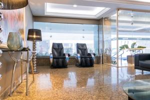 a lobby with two chairs and a table at Braston Augusta Hotel by Castelo Itaipava in Sao Paulo +23 photos