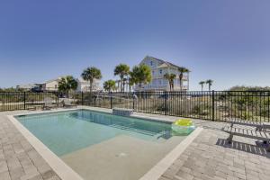 a swimming pool with a fence and a house at Beachfront Paradise with Pool on St George Island! in St. George Island