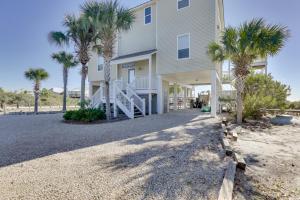 a house with palm trees in front of it at Beachfront Paradise with Pool on St George Island! in St. George Island
