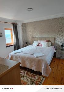 a bedroom with a bed with a laptop on it at Beach House Apartment in Side