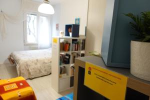 a room with a tv and a bedroom with a bed at Academia in Cremona