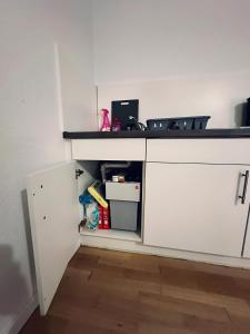 a kitchen with a white cabinet with a counter at sleepWELL-Horstmar Zentral & Kirchennah in Horstmar +14 photos