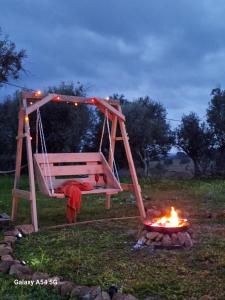 a swing over a camp fire in a field at Monte da Masmorra de baixo-Casa Alentejana in Montemor-o-Novo
