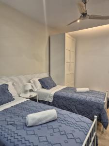 a bedroom with two beds with blue and white at 18 HABITACIÓN EN VIVIENDA CENTRICA BILBAo in Bilbao