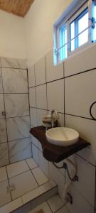 a bathroom with a sink and a window at Rincón SierraVista in Cosquín +13 photos