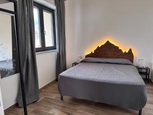 a bedroom with a bed with a fireplace on the wall at Guest House Bonheur in Paesana