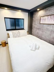 Ένα ή περισσότερα κρεβάτια σε δωμάτιο στο 福源阁-独栋-别墅-新深江站步行5分-難波-心斋桥直达-便捷前往京都奈良