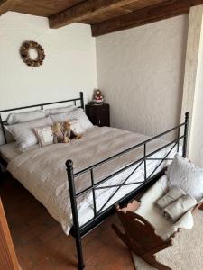 a bedroom with a bed and a chair at Fairytale cottage Francka in Gorica pri Slivnici