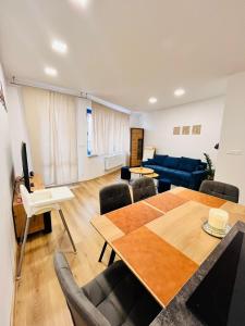 a living room with a table and a blue couch at Franco Piešťany Apartments 1 in Piešťany