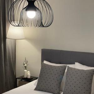 a bedroom with a bed with a chandelier above it at Hej Hi Home II in Seoul