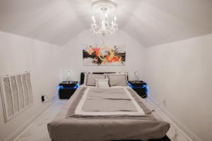 a bedroom with a large bed and a chandelier at Stunning 6BR Victorian Sleeps 25 in San Antonio