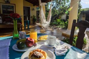 a table with plates of breakfast food and orange juice at La Casona Hotel Boutique in Asunción