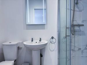 a bathroom with a toilet and a sink and a shower at Central Hub For Maidstone, Cosy Suite Book Now in Maidstone