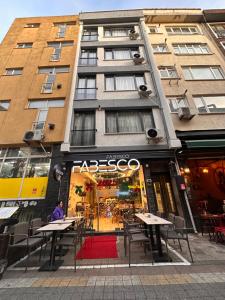 a store with tables and chairs in front of a building at Fabesco Suite in Istanbul