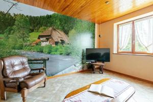โทรทัศน์และ/หรือระบบความบันเทิงของ Appartement spacieux à Epfig avec vue sur le jardin