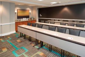 a classroom with tables and chairs and a chalkboard at Residence Inn Toledo Maumee in Maumee +21 photos