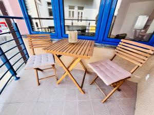 a wooden table and two chairs on a balcony at Franco Piešťany Apartments 1 in Piešťany +11 photos