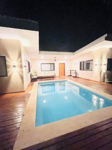 a large swimming pool in the middle of a room at Cosmos House in the Jungle in Santa Teresa Beach