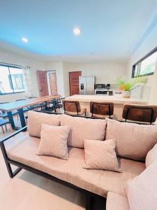 a living room with a couch and a table at Cosmos House in the Jungle in Santa Teresa Beach