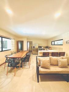 a kitchen and dining room with a table and chairs at Cosmos House in the Jungle in Santa Teresa Beach