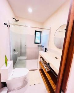 a bathroom with a toilet and a sink and a shower at Cosmos House in the Jungle in Santa Teresa Beach