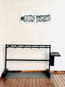 a bench in a room with two pictures on the wall at Cosmos House in the Jungle in Santa Teresa Beach