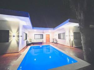a large swimming pool in a living room at night at Cosmos House in the Jungle in Santa Teresa Beach