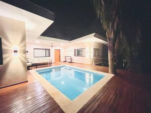 a large swimming pool in the middle of a house at Cosmos House in the Jungle in Santa Teresa Beach