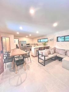 a living room with a couch and a table at Cosmos House in the Jungle in Santa Teresa Beach