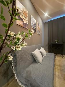 a couch in a living room with flowers on the wall at CITY FLATS - Avenida Baleares in Valencia