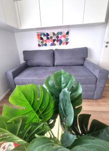a living room with a couch and a large plant at RentinAustria in Reisenberg