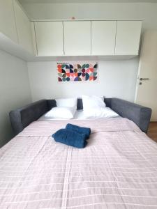 a bed with a blue pillow on top of it at RentinAustria in Reisenberg