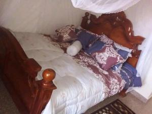 Postel nebo postele na pokoji v ubytování ACP Hotel-Kigogwa