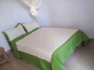 Postel nebo postele na pokoji v ubytování ACP Hotel-Kigogwa