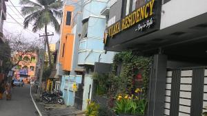a building with a sign on the side of a street at Vijaya Residency - Porur in Chennai