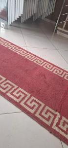 a red rug on the floor of a building at الهرهورة in Oulad Kerroum