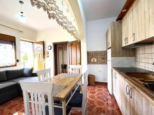 a kitchen and living room with a table and chairs at Beach & Chill Apartments in Vlorë +45 photos