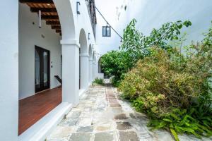 an alleyway of a house with white walls at 150 Sol by Stay with Bear in San Juan