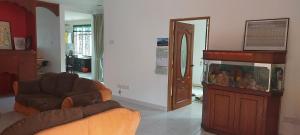 a living room with a couch and a fish tank at Skudai close to JB Town Corner House in Johor Bahru