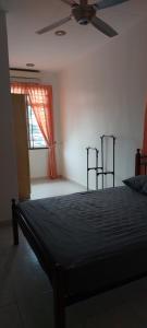 a bedroom with a bed and a ceiling fan at Skudai close to JB Town Corner House in Johor Bahru